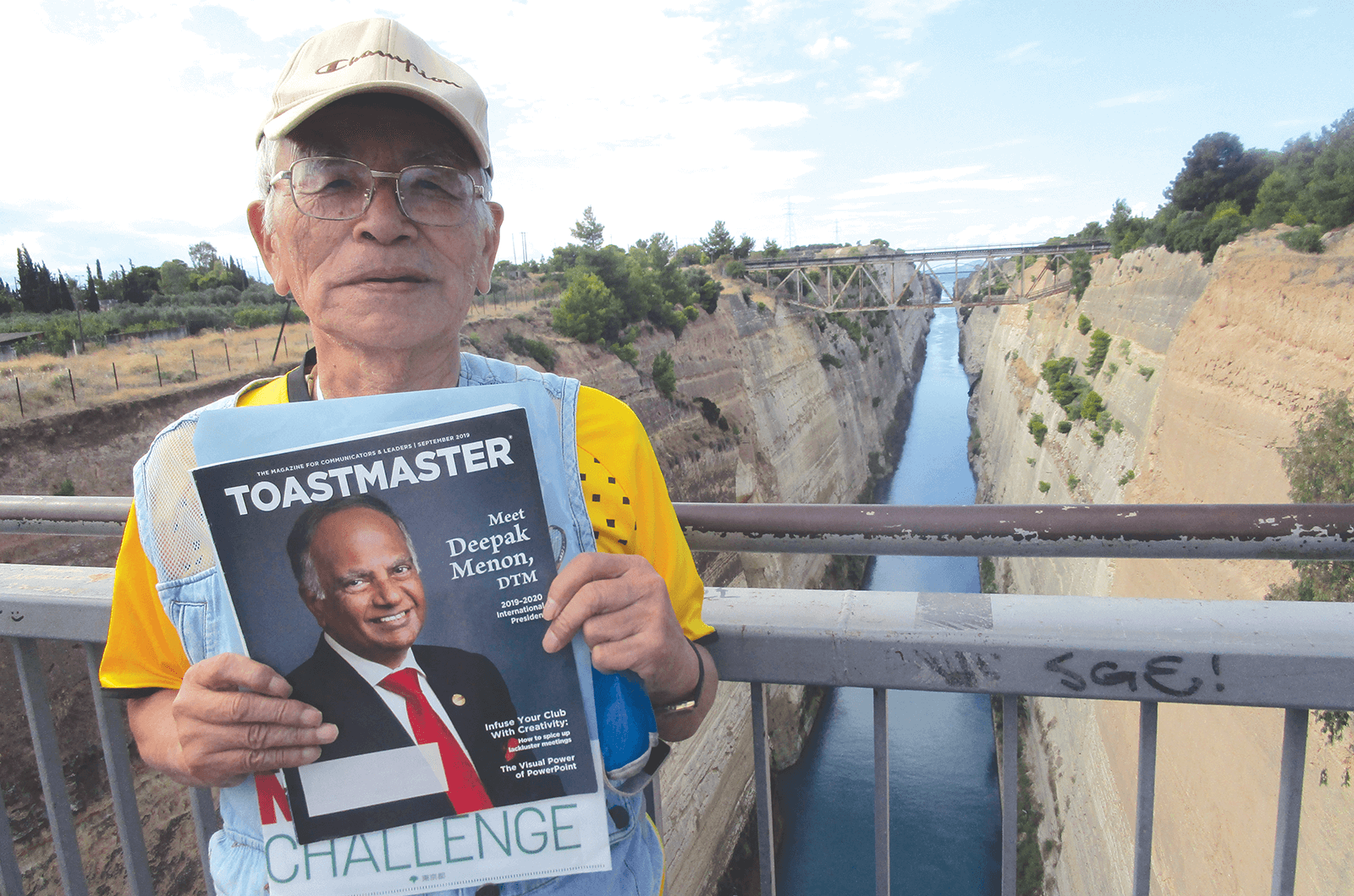 Masatoshi Denko of Tokyo, Japan, stands on a bridge above the Corinth Canal in Greece. The canal connects the Gulf of Corinth with the Saronic Gulf in the Aegean Sea.