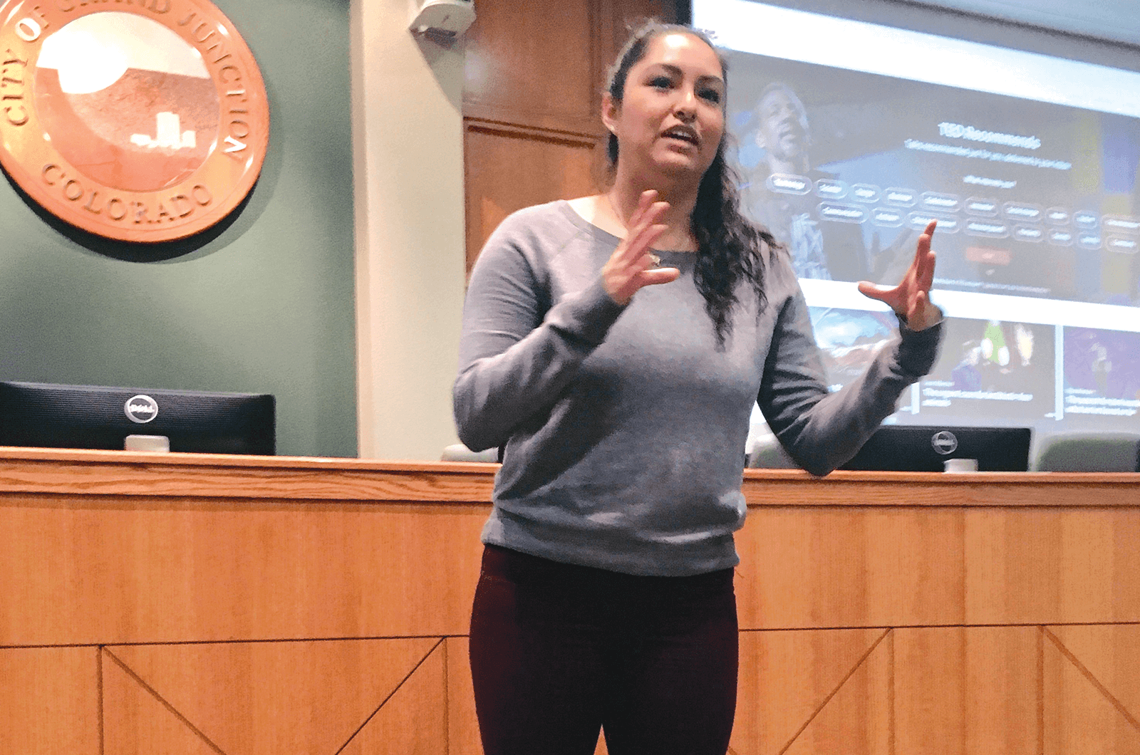 Young woman speaking with hand gesture