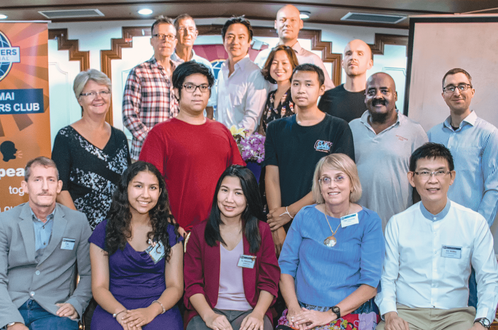 
Members of the Chiang Mai club smiling and posing with banner