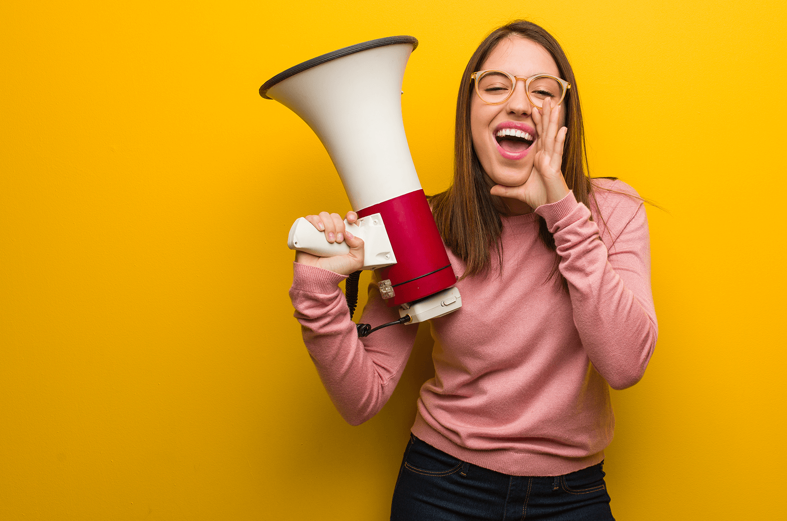 Woman in pink shirt holding megaphone speaker