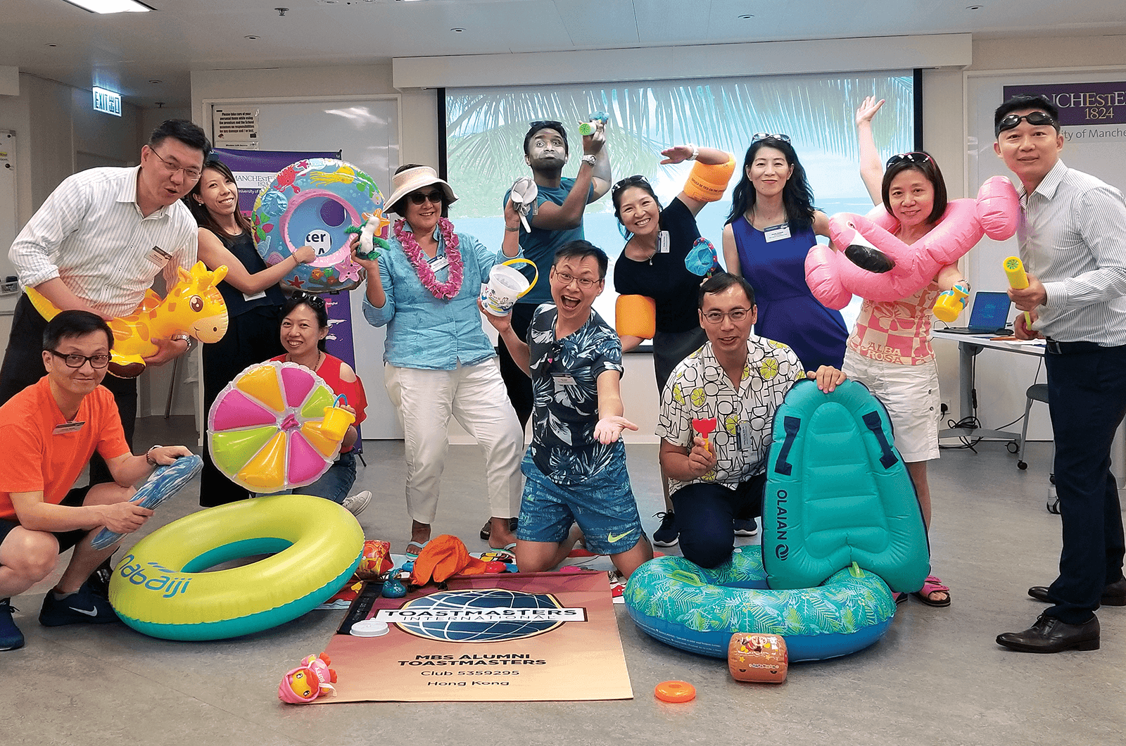 Group of Toastmasters members with beach-themed props