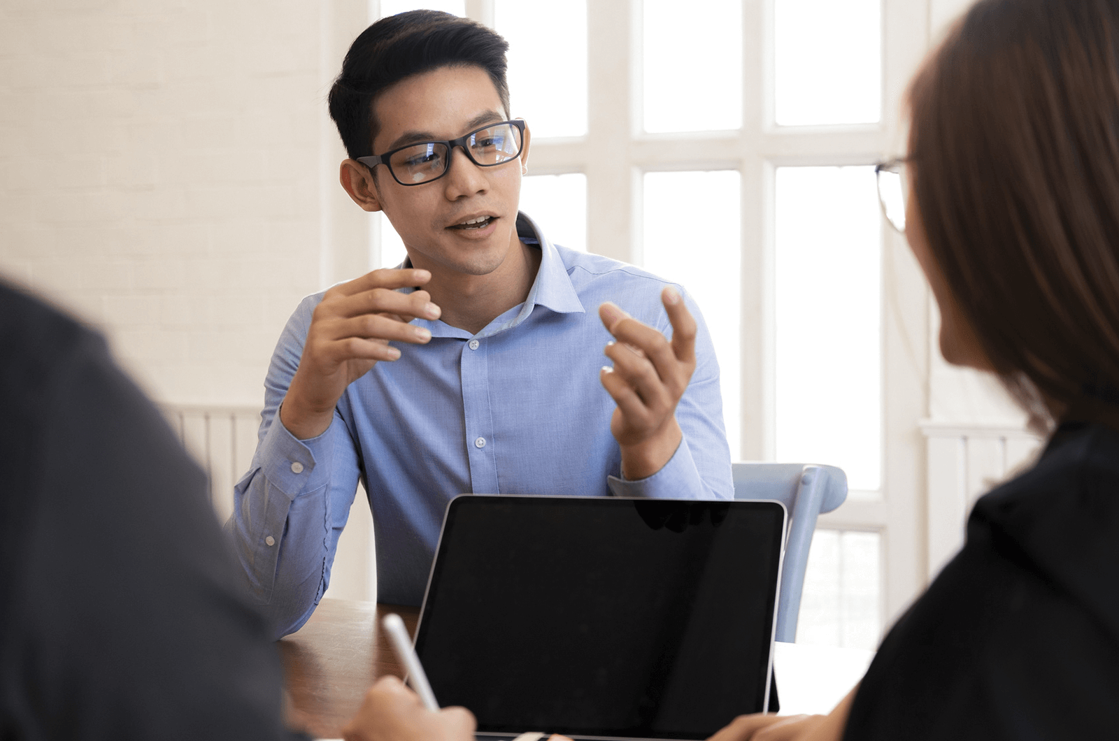 Man in blue shirt and glasses interviewing with woman