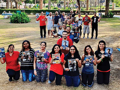 Toastmasters members form an "I' formation outdoors