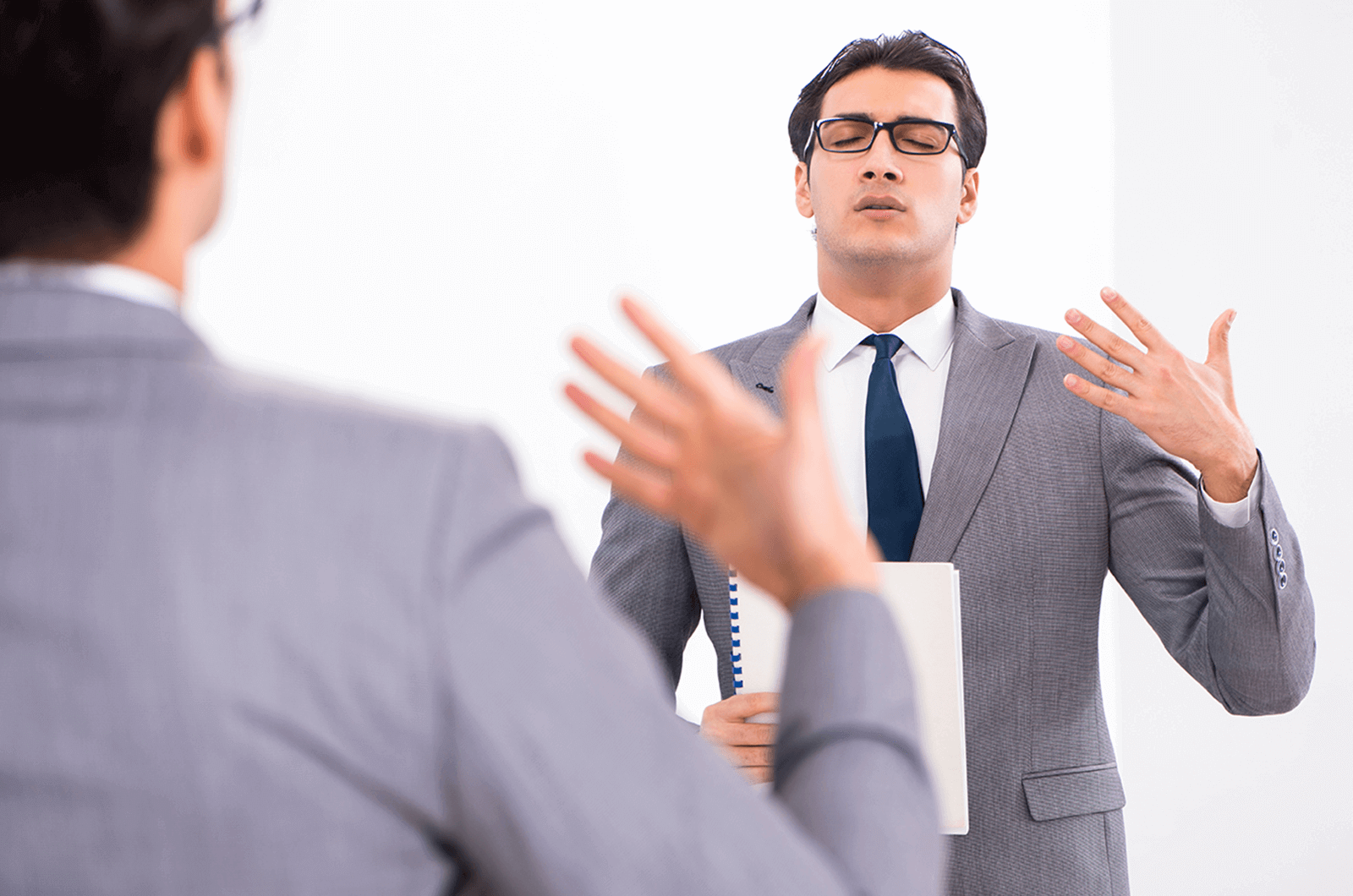 Man looking in mirror warming up for speech