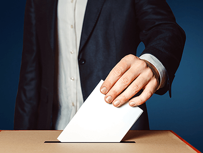 Man dropping piece of paper in ballot box