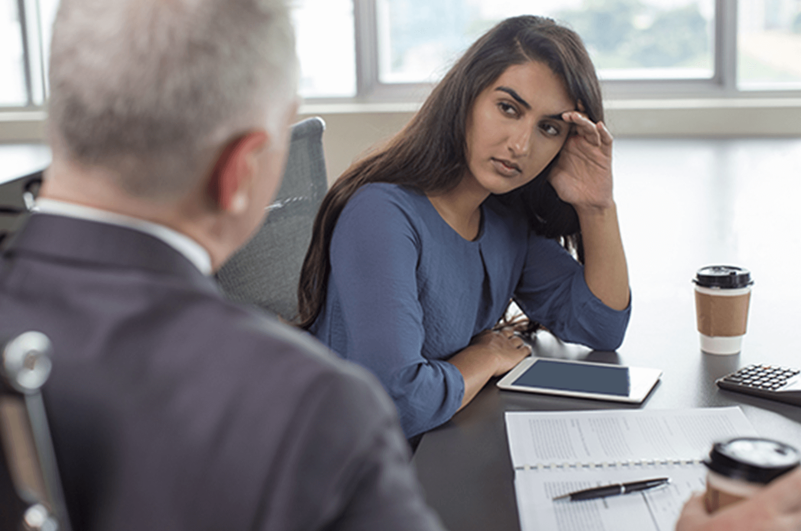 Woman in blue shirt receiving feedback from man