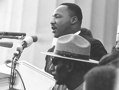 Martin Luther King Jr. speaking into microphone