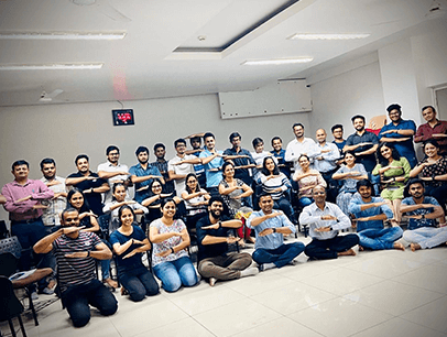 Group of Toastmasters in India posing with arms making equal signs