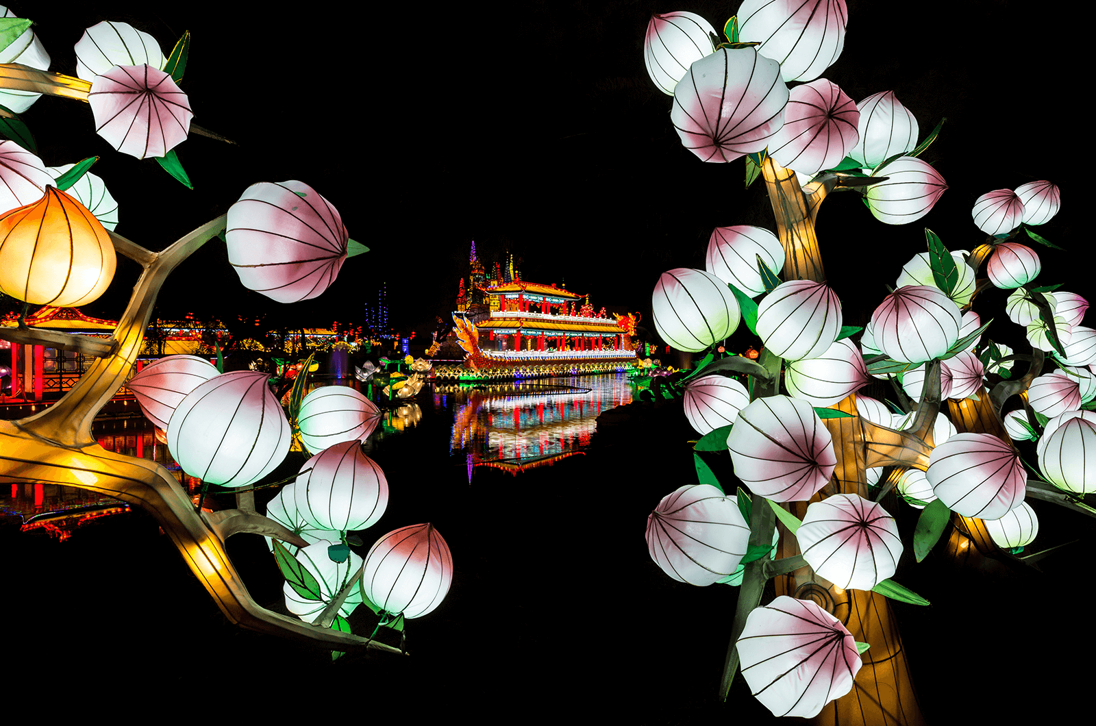 Framed image with lit up dragon boat in background