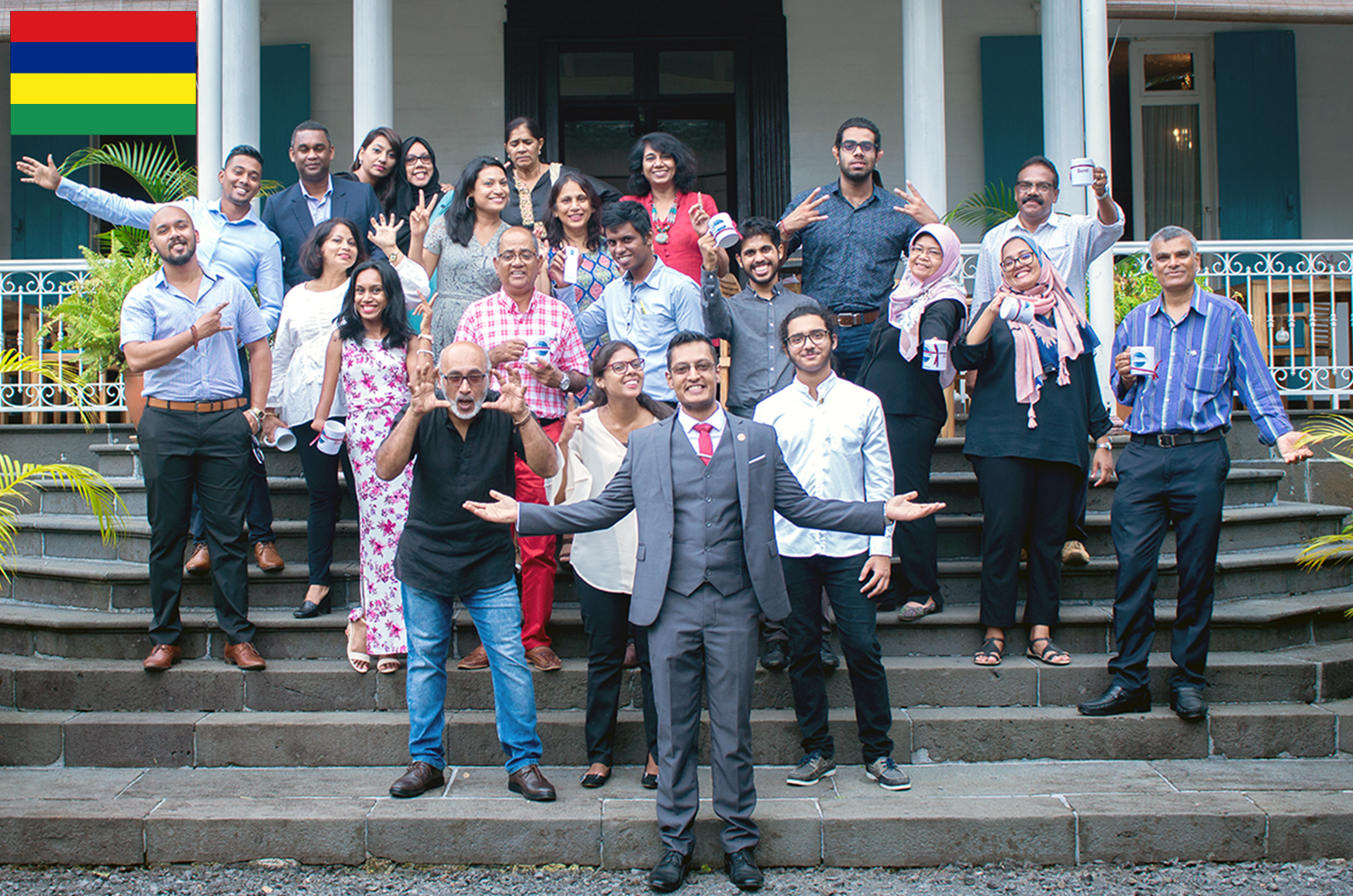 Group of people posing with gestures on staircase