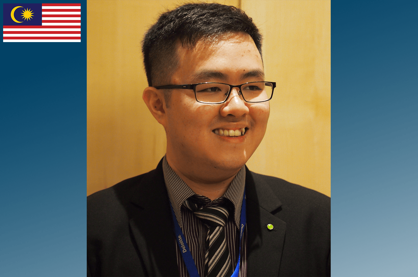 Man in suit and tie wearing glasses smiling