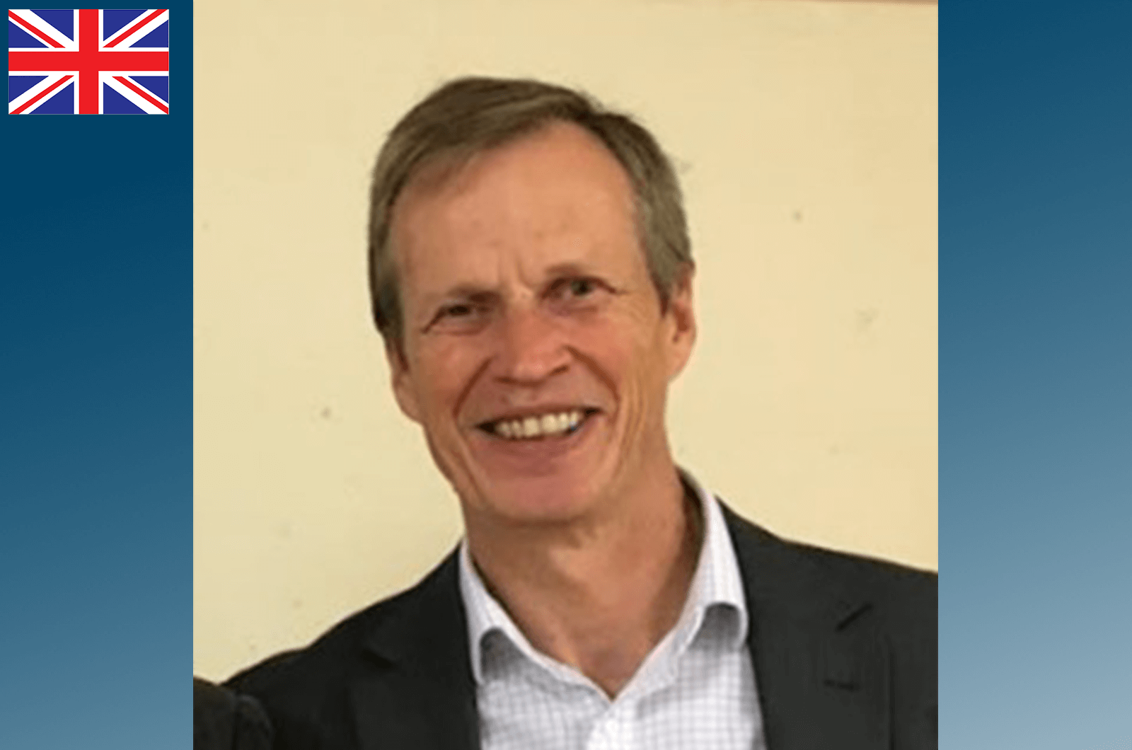 Man in suit jacket smiling at camera 