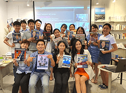 Group of people posing with Toastmaster magazines  