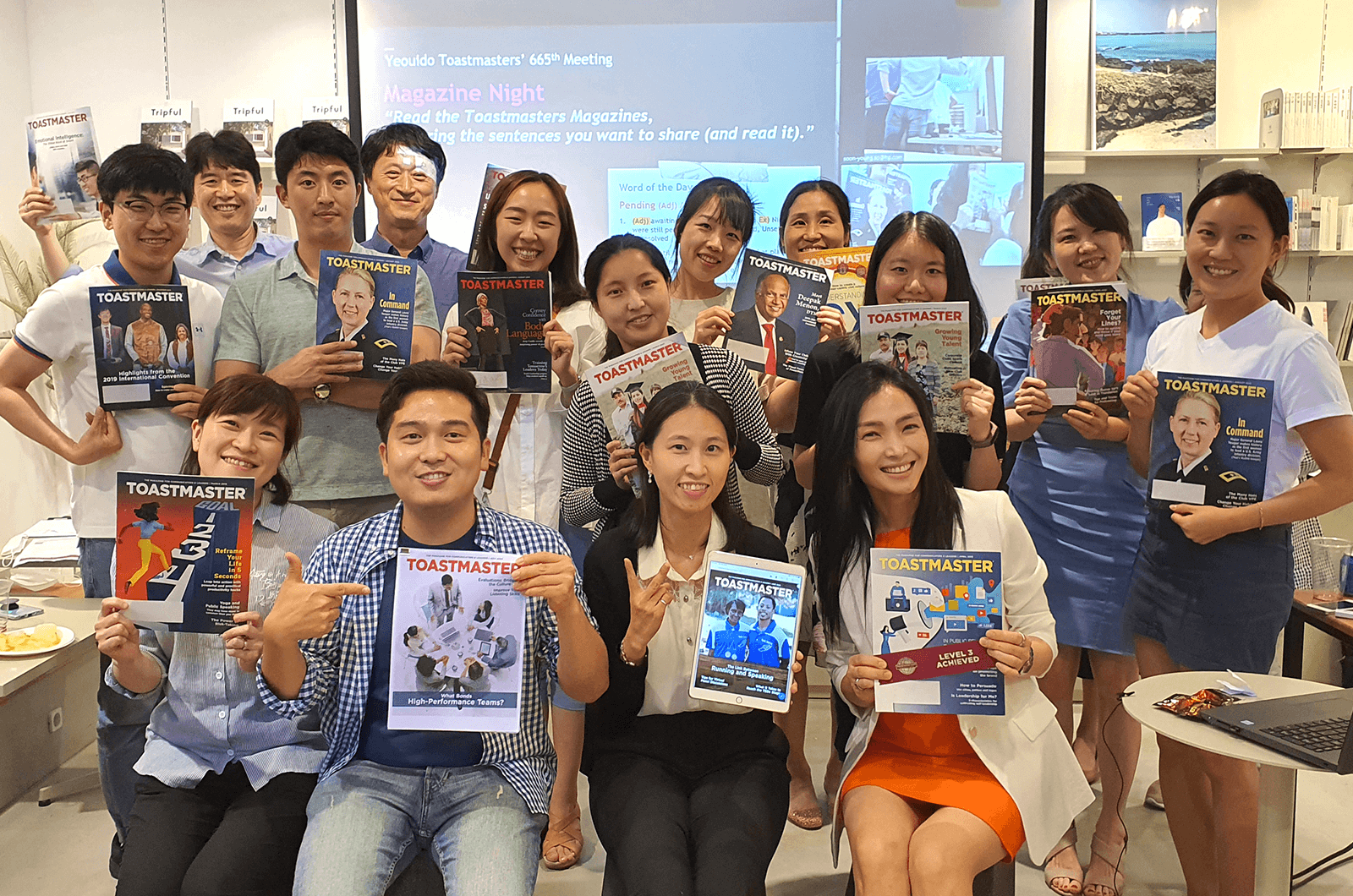 Group of people posing with Toastmaster magazines