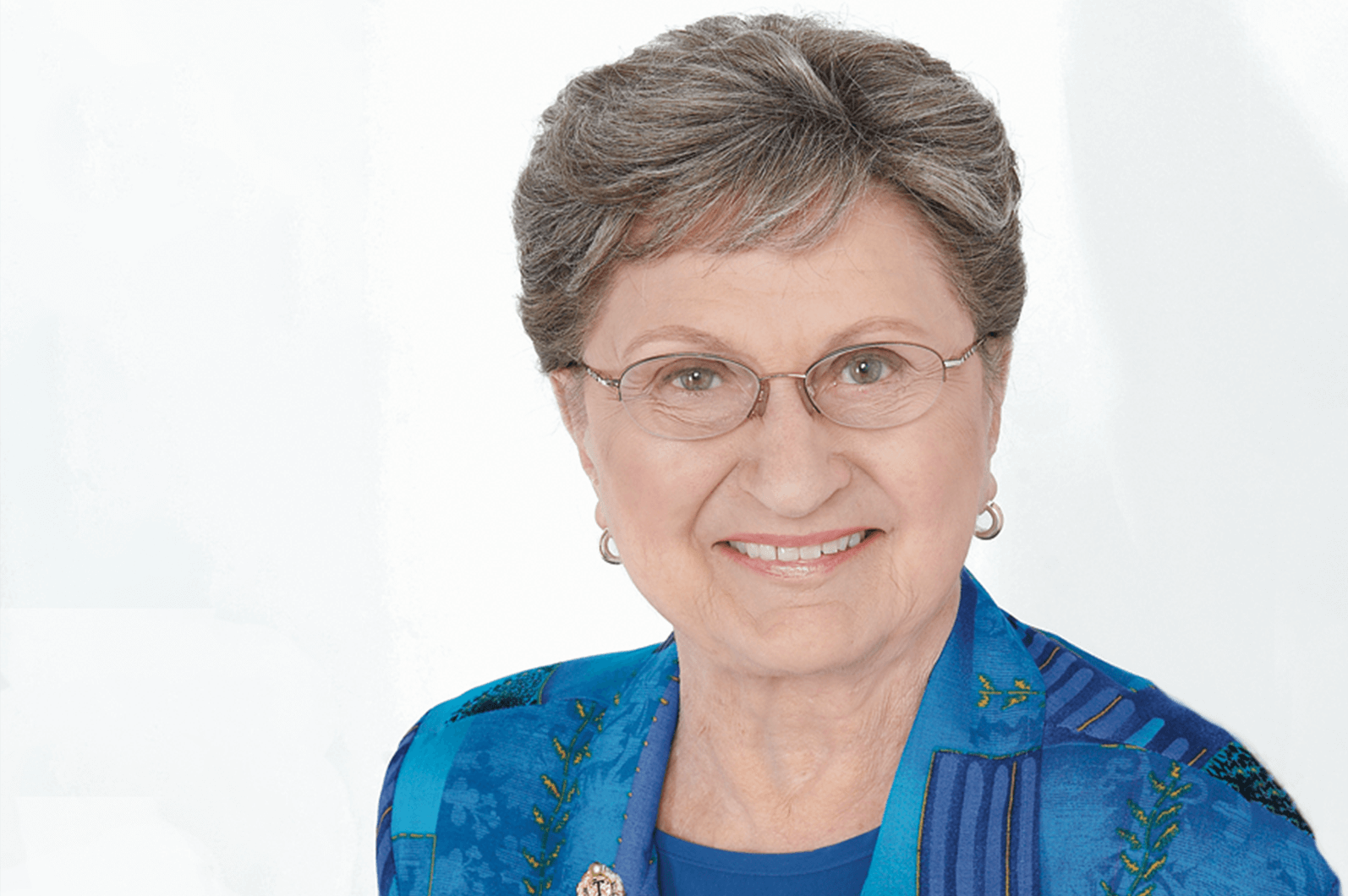 Helen Blanchard in blue outfit with Toastmasters pin