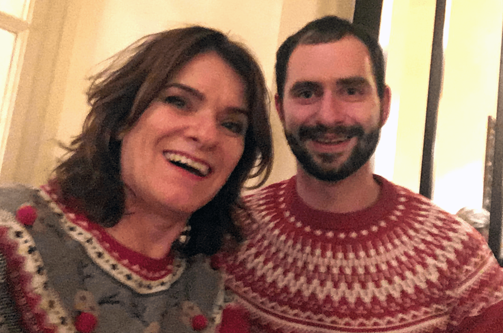 Man and woman posing in sweaters