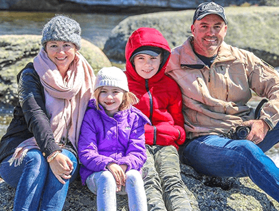 Family with two kids posing outdoors