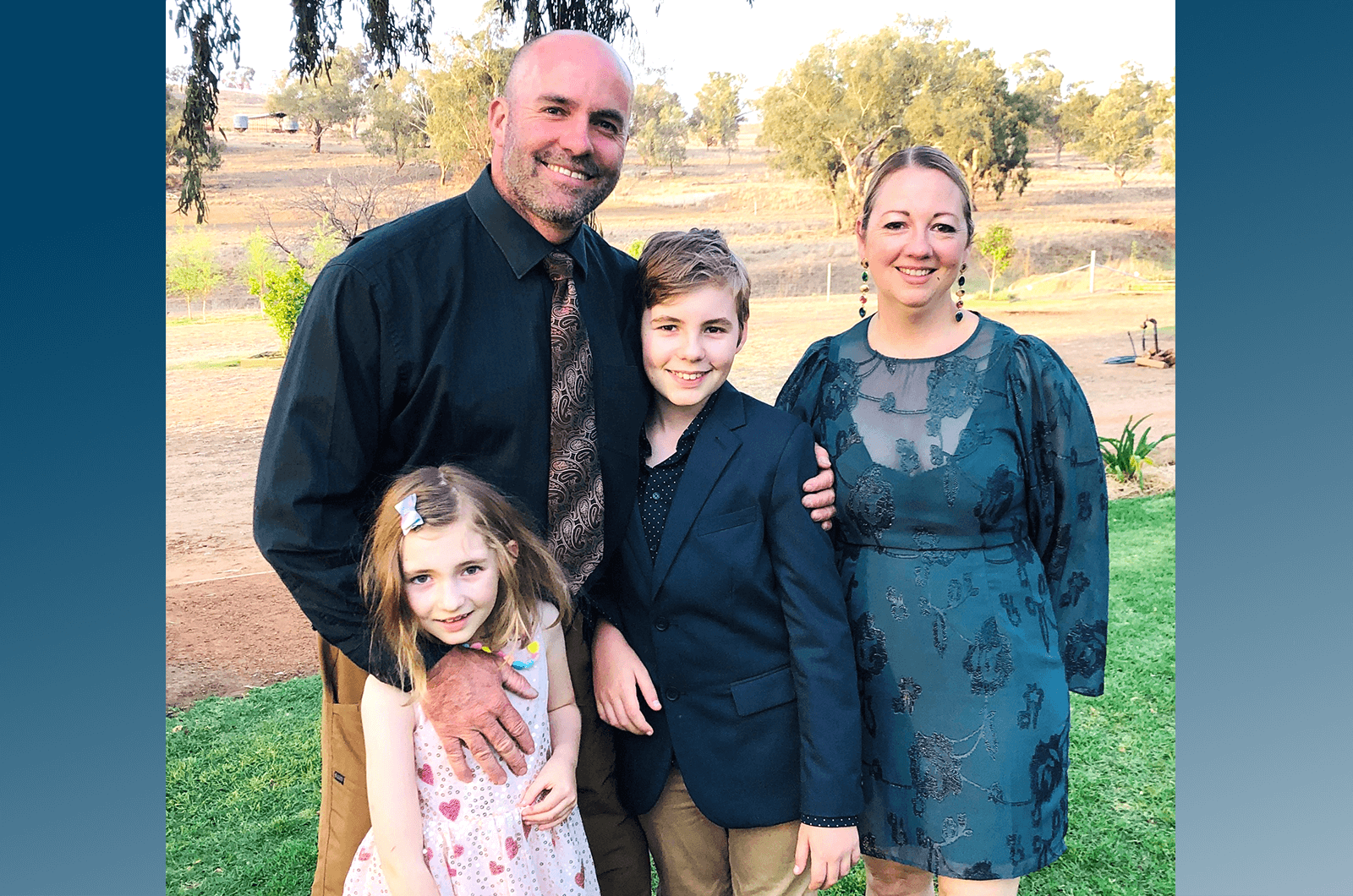 Family with two kids posing outdoors