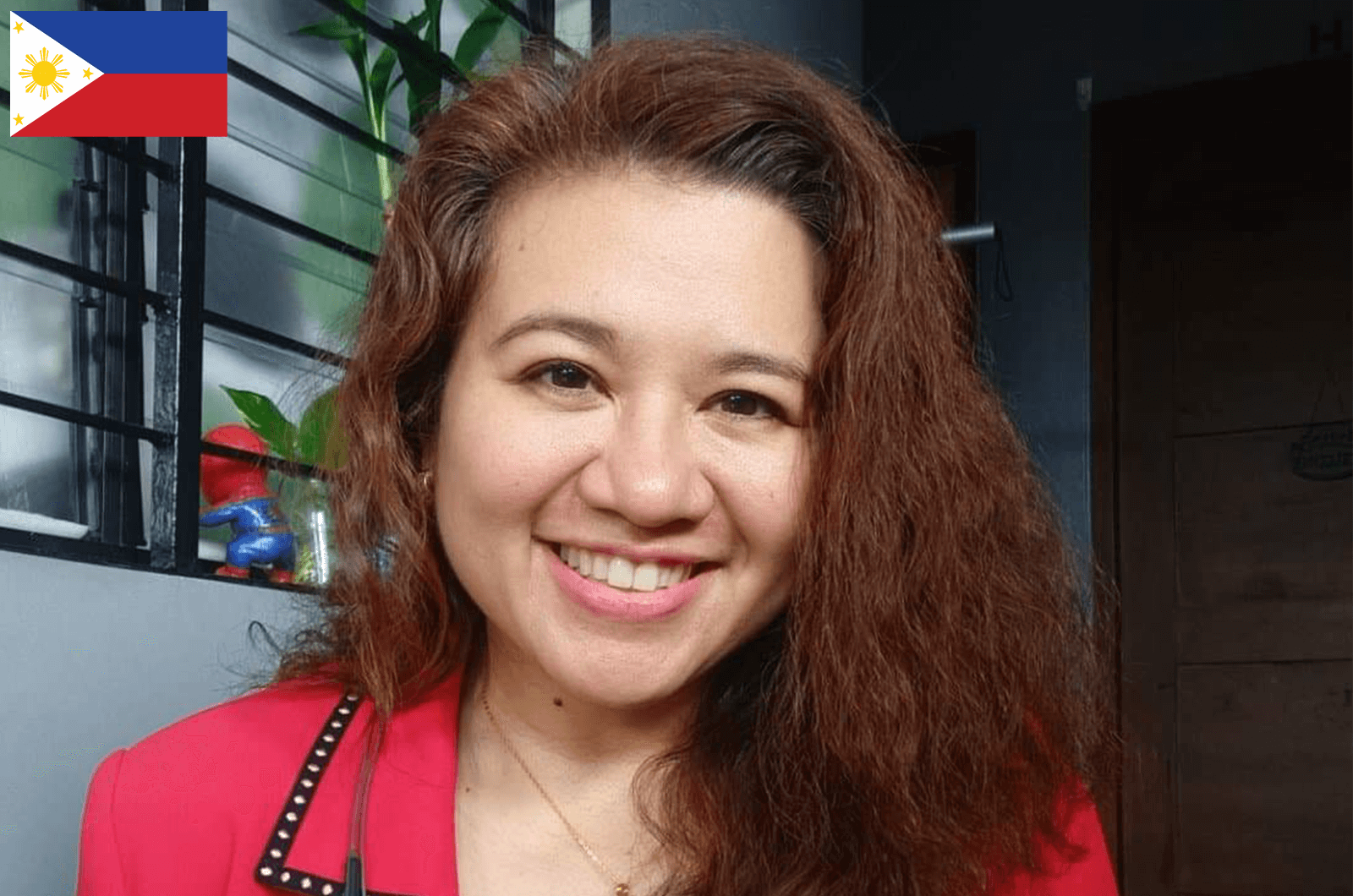 Woman in red jacket smiling 