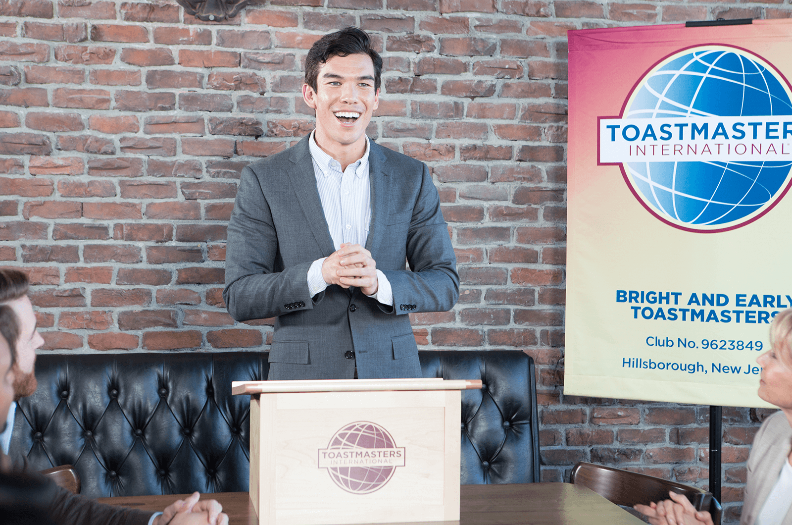 Man standing at lectern speaking