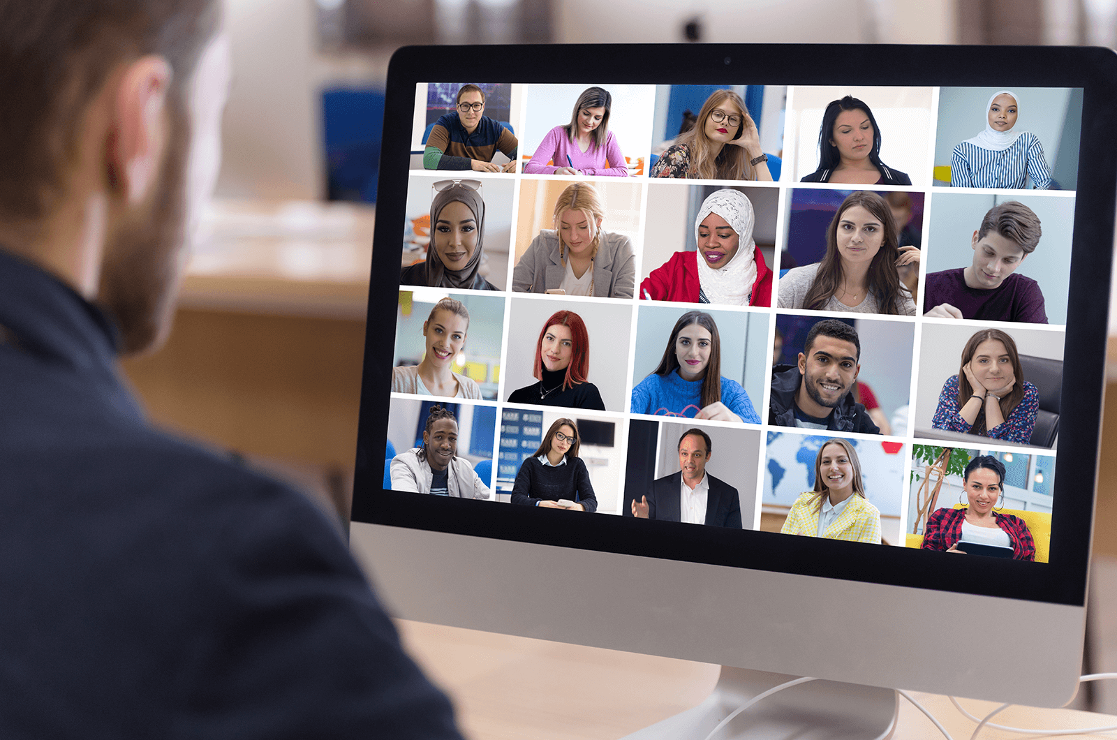 Man meeting with group of people virtually on computer