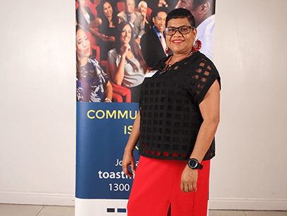 Woman in black shirt smiling at camera