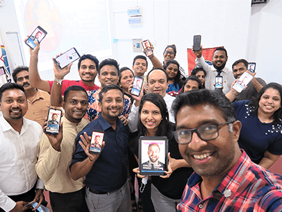 Sri Lanka Institute of Marketing Toastmasters Club members in Colombo, Sri Lanka, pose with the digital edition of the Toastmaster at their club meeting.