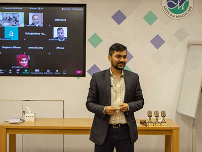 Man speaking at front of room