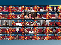 People on Zoom meeting holding oranges