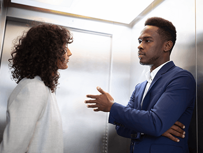 Man and woman speaking in elevator