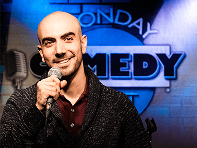 Man holding microphone on comedy stage