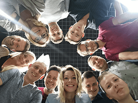 Group of people looking down at camera