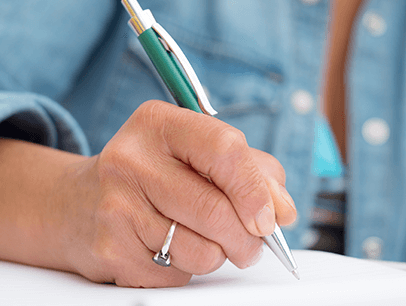 Woman writing on paper with pen