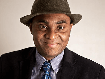 Man dressed in suit, tie, and hat