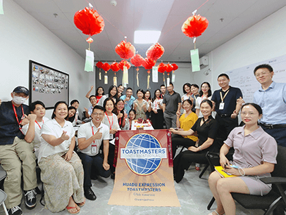 Group posing around banner