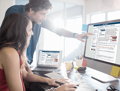 Man pointing to computer screen next to woman