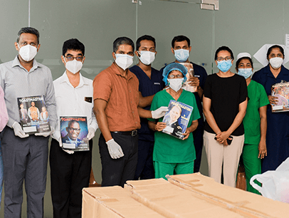Group posing in masks holding magazines
