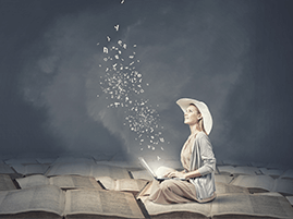 Woman in hat writing on laptop