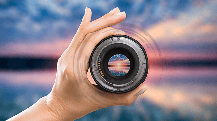 Hand holding camera lens