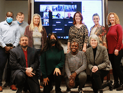 Group posing in front of screen