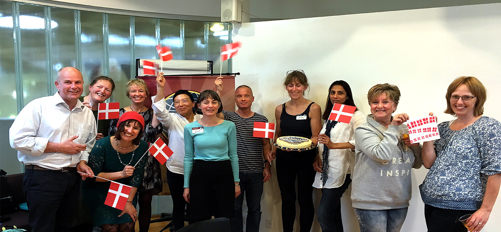 Toastmasters in Fredensborg, Denmark, celebrate the club's 6th anniversary in traditional Danish style with flags and cake.